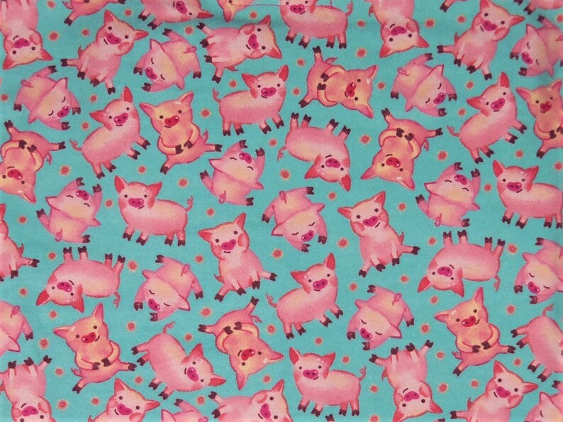 May include: A fabric pattern featuring numerous pink pigs in various poses against a teal background dotted with small orange circles. The pigs have smiling faces and are in different positions.