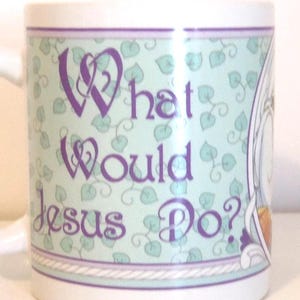 May include: A white ceramic mug featuring a light green background with a repeating pattern of small dark green leaves. The text "What Would Jesus Do?" is printed in a purple decorative font. The design is bordered by thin purple and white lines.