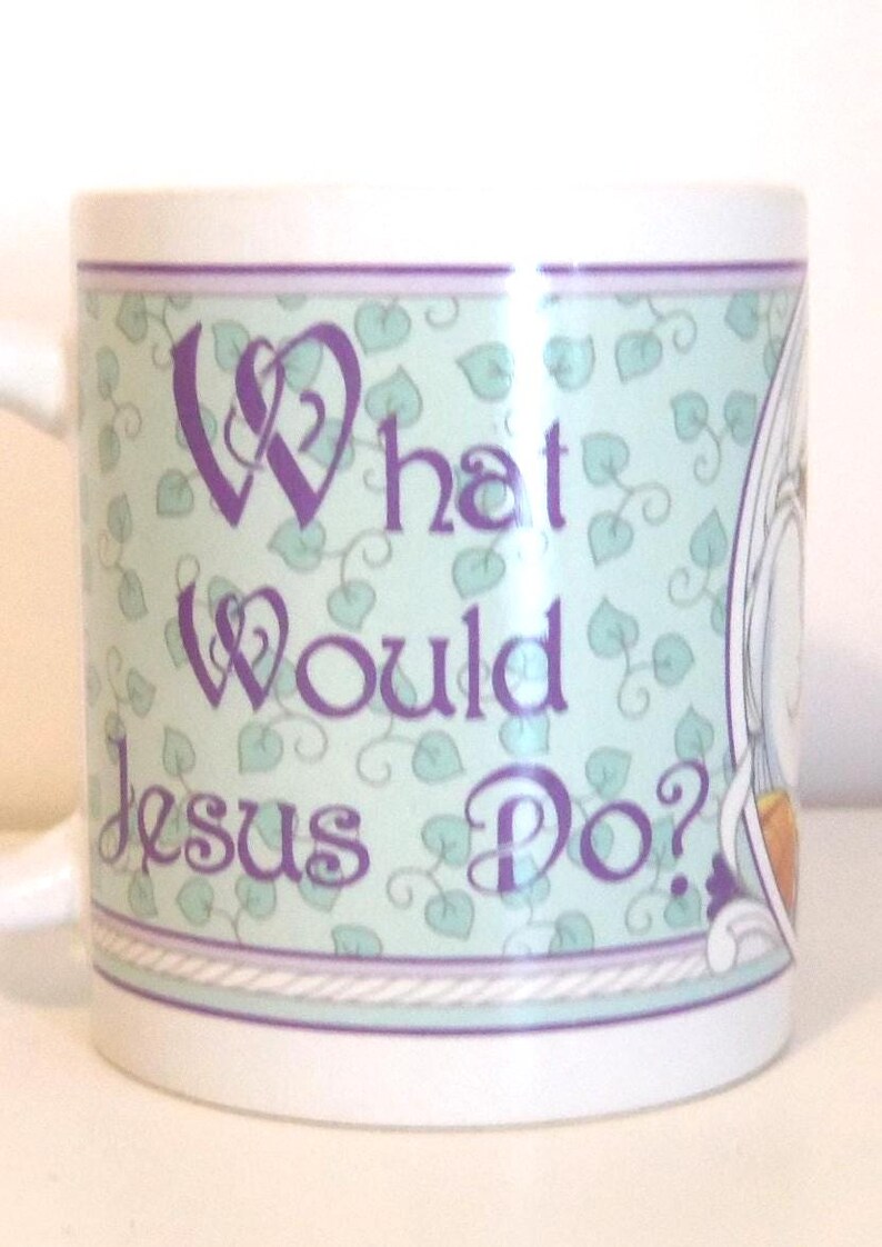 May include: A white ceramic mug featuring a light green background with a repeating pattern of small dark green leaves. The text "What Would Jesus Do?" is printed in a purple decorative font. The design is bordered by thin purple and white lines.