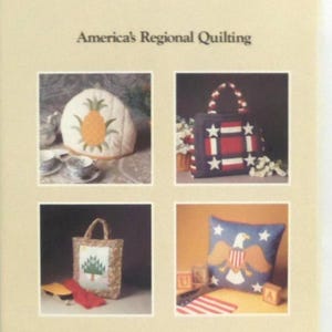 May include: A book titled America's Regional Quilting featuring four images: a pineapple-patterned tea cozy, a red, white, and blue star-patterned tote bag, a tree-patterned tote bag, and a blue pillow with a bald eagle and star design.