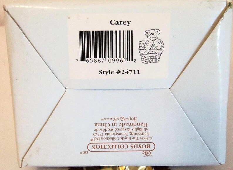 May include: A white box with a label that reads "Carey" above a barcode and a small illustration of a teddy bear in a basket. The style number is #24711. The box is from The Boyds Collection.