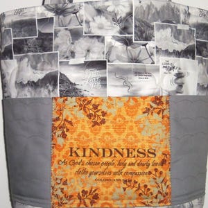 May include: A tote bag with a patchwork design. The top and bottom sections feature a collage of black and white images. The center has a gray panel with an orange floral design and the word "KINDNESS".