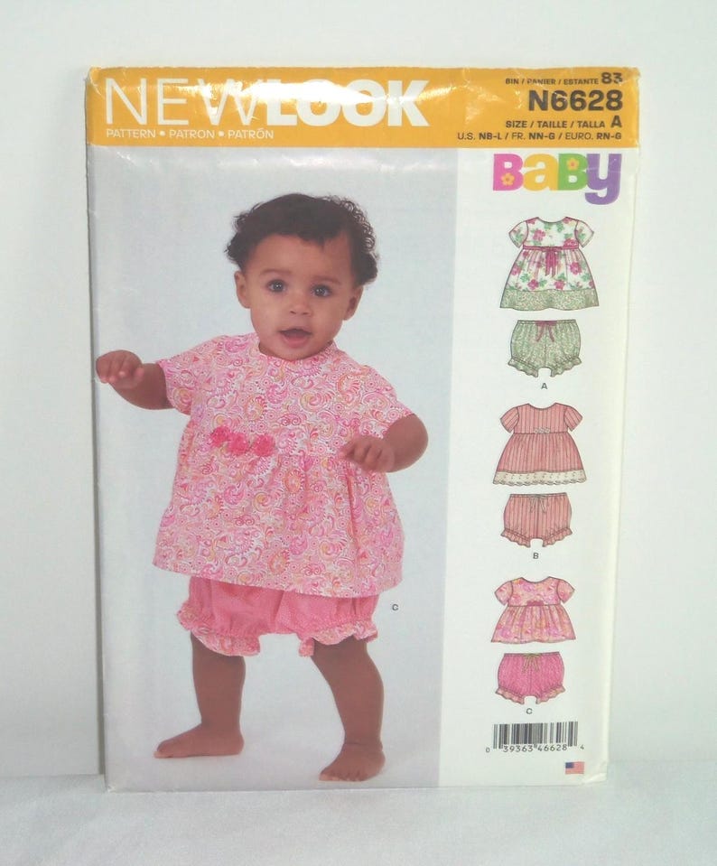 May include: A baby wearing a pink floral print outfit, including a top and shorts. The image is on a New Look pattern envelope, with the word "Baby" in colorful letters. The pattern number is N6628.