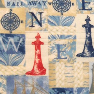 May include: A nautical-themed fabric with a patchwork design. The design features compasses, lighthouses, and the words "SAIL AWAY" and "W E". The color palette includes shades of blue, beige, and red.