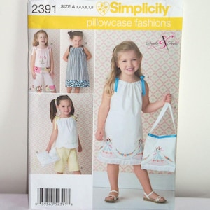 May include: Simplicity sewing pattern number 2391 for pillowcase fashions. The pattern includes instructions for making a dress, a tote bag, and a pair of shorts. The pattern is for sizes A 3, 4, 5, 6, 7, and 8.