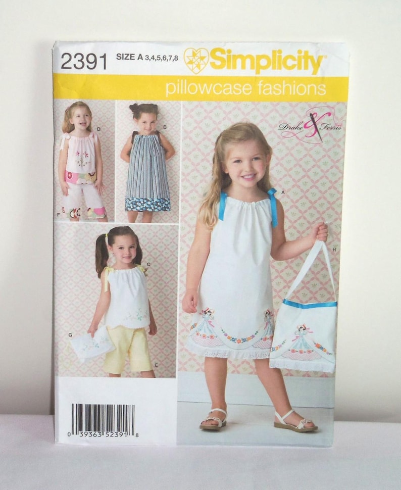 May include: Simplicity sewing pattern number 2391 for pillowcase fashions. The pattern includes instructions for making a dress, a tote bag, and a pair of shorts. The pattern is for sizes A 3, 4, 5, 6, 7, and 8.