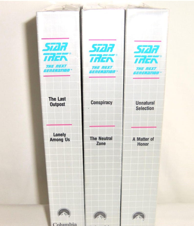 May include: Three white VHS tape cases for Star Trek The Next Generation, each featuring a grid pattern, teal and pink text, and episode titles including The Last Outpost, Lonely Among Us, Conspiracy, The Neutral Zone, Unnatural Selection, and A Matter of Honor.