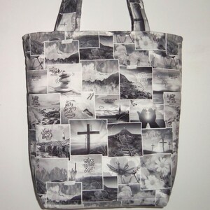 May include: Black and white tote bag with a patchwork design featuring religious imagery. The bag displays images of crosses, landscapes, and inspirational text. It has two handles for carrying.