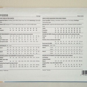 May include: A sewing pattern for a misses' dress in two lengths. The pattern includes size charts in both inches and centimetres, as well as instructions for cutting and sewing the dress. The pattern is labelled R12233.