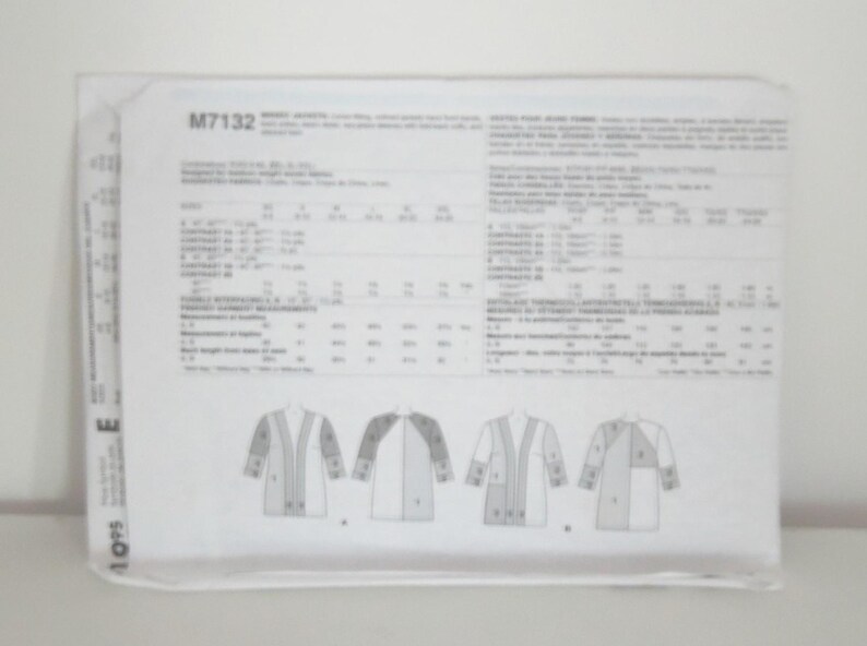 May include: A white sewing pattern envelope labeled M7132 for jackets. The back of the envelope displays technical illustrations of two jacket styles, labeled A and B, along with detailed sizing charts, fabric requirements, and instructions in English.