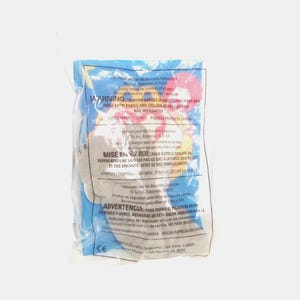 May include: A small, grey plush toy sealed inside a clear plastic bag. The packaging features printed safety warnings in English, French, and Spanish, along with the McDonald's Corporation logo and copyright information from 1999, all in black text.