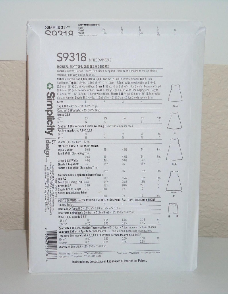 May include: A white Simplicity sewing pattern envelope S9318 for toddlers' tent tops, dresses, and shorts. The back of the envelope displays technical information, fabric requirements, size charts in metric, and line drawings of the garments.