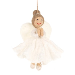 May include: A white felt angel ornament with brown hair, a white dress, and white wings. The angel is holding its hands together in a prayer position.
