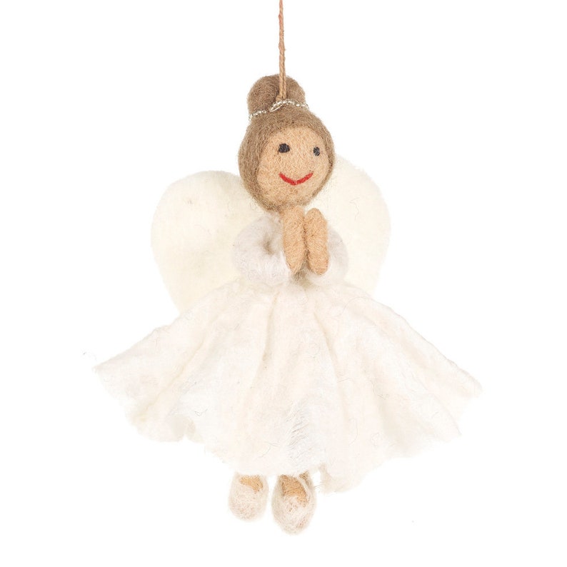 May include: A white felt angel ornament with brown hair, a white dress, and white wings. The angel is holding its hands together in a prayer position.