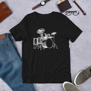 May include: Black t-shirt featuring a white graphic of a drum kit. The kit includes a bass drum, snare drum, two toms, and cymbals.