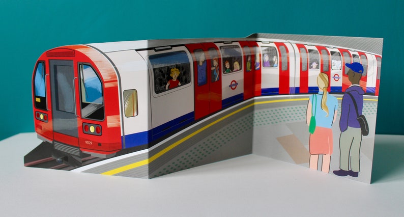 May include: A red and white London Underground train with passengers looking out the windows. Two people are waiting on the platform. The train is on a track with a yellow line and a gray platform.