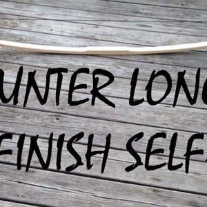 May include: A 64" unfinished wooden longbow for archery. The bow is made of wood and is ready to be finished. "64" HUNTER LONGBOW YOU-FINISH SELF-BOW is written in black text on the wooden surface.