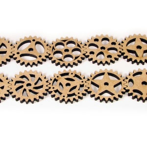 May include: Ten wooden gears with different designs, including a star, a swirl, and a circle with dots. The gears are all brown and have black edges.