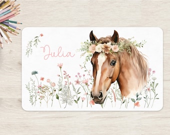 May include: A watercolour illustration of a brown horse with a floral crown. The horse is surrounded by pink and white flowers and green leaves. The name "Julia" is written in pink script at the top of the image.