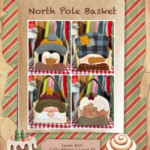 May include: Four Christmas-themed fabric baskets featuring different characters: a penguin, a snowman, Santa Claus, and a gingerbread man. The baskets are decorated with plaid, gingham, and other festive fabrics. The text "North Pole Basket" is at the top of the image. The text "Laura Mori, Calle Hibisco 1 Local 55, CC el Campanario, 35660 Corralejo, www.Lauramoripatch.com" is at the bottom of the image.