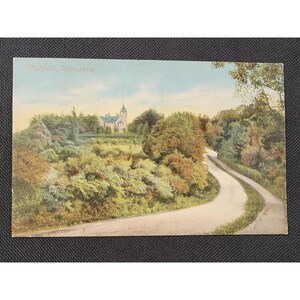 May include: Vintage postcard featuring a scenic view of Highfield, Uppingham. The image shows a winding road leading towards a building with a tall steeple, surrounded by lush greenery and trees. The sky is a soft blue, and the overall tone is nostalgic.