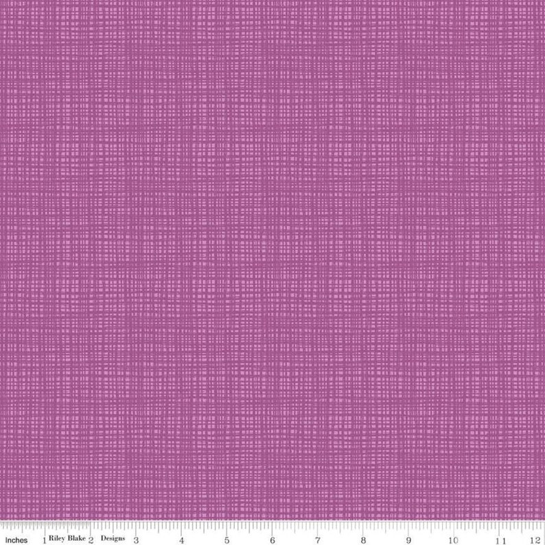 May include: A close-up of a pink fabric with a woven texture. The fabric has a subtle, light pink color and a fine, even weave.