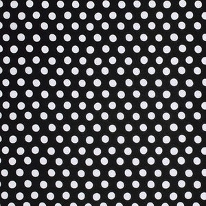May include: Black fabric with a white polka dot pattern.