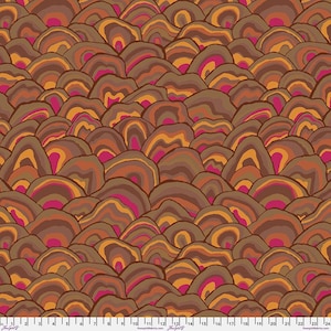 May include: A repeating pattern of abstract, layered shapes in shades of brown, orange, and pink. The design resembles a stylized landscape or geological formation, creating a textured, organic feel. The fabric has a warm, earthy color palette.