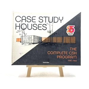 May include: A hardback book titled Case Study Houses: The Complete CSH Program 1945-1966 by Taschen. The cover features a diagonal split design with a black and white architectural sketch on the left and a dark grey background on the right.