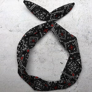 May include: Black bandana headband with a white and red paisley pattern.