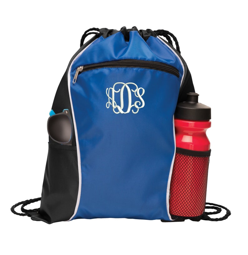 May include: A blue and black drawstring bag with a white zipper and a white monogram. The bag has a side pocket for a water bottle and a mesh pocket for a water bottle.
