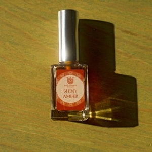 Shiny Amber olfactory art in a 15ml bottle, warm fragrance with lemon, bergamot, ginger, jasmine, champaka, labdanum, benzoin and vanilla image 1