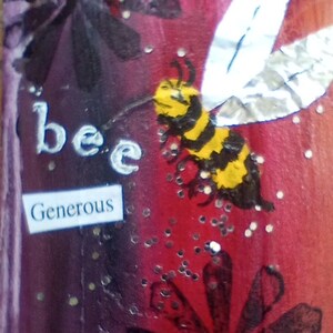 May include: A colorful artwork featuring a bee with yellow and black stripes and silver wings. The word "bee" is written in white, and the word "Generous" is on a small white rectangle. The background is a mix of red, purple, and black.