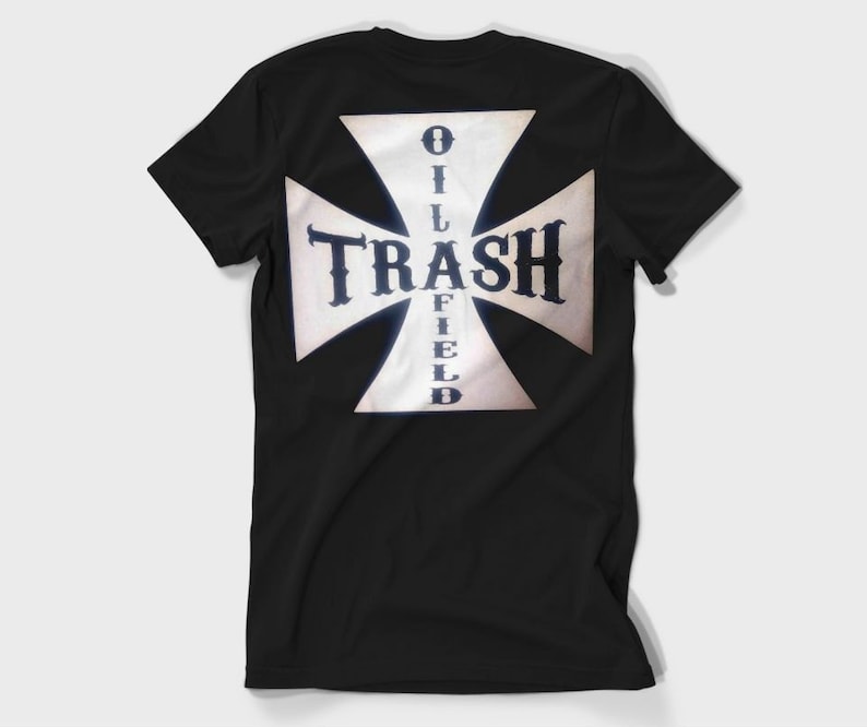 May include: Black t-shirt with a white cross and the text "OILFIELD TRASH" printed on the back.