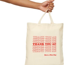 May include: A beige canvas tote bag with red text that says "THANK YOU AI!" repeated multiple times. The text is in a retro font style. The bag has two handles and the text "Have a Nice Day" is printed below the repeated text.