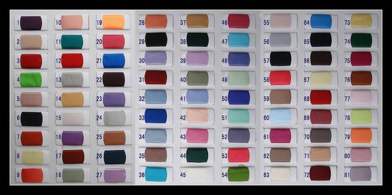 May include: A fabric color swatch chart featuring eighty-one numbered rectangular samples arranged in three vertical columns. Each swatch displays a distinct solid color, ranging from neutrals and pastels to vibrant primary and secondary hues.