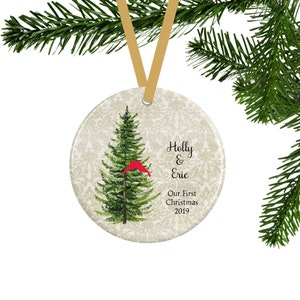 A personalized first Christmas ornament for couples with a green pine tree and 2 red lovebirds.