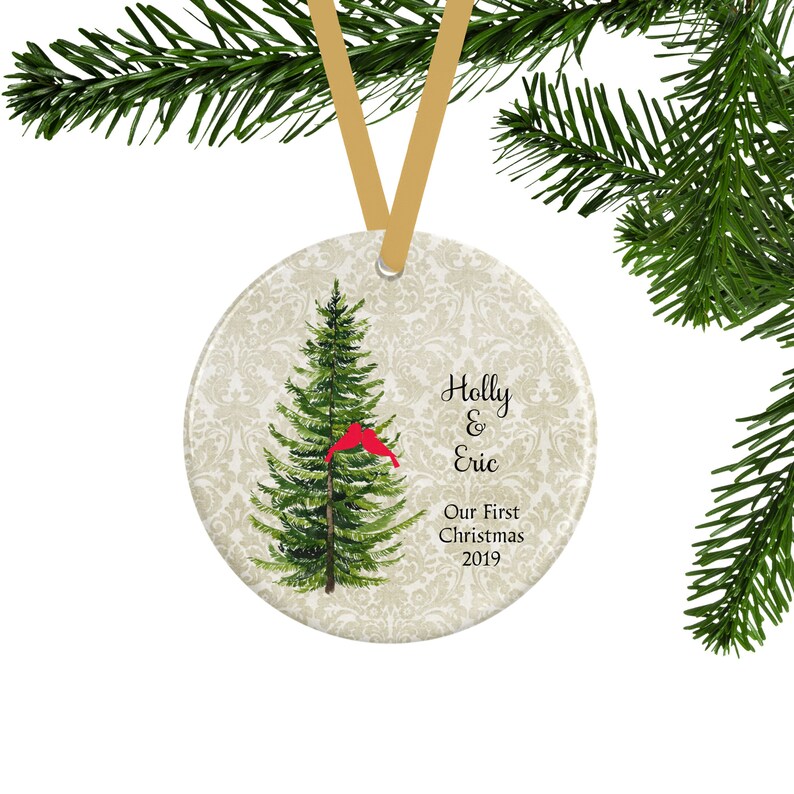 A personalized first Christmas ornament for couples with a green pine tree and 2 red lovebirds.