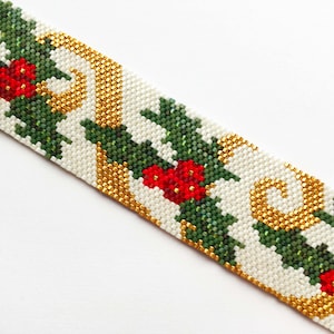 May include: A white, green, gold, and red beaded bracelet with a holly and berry design.