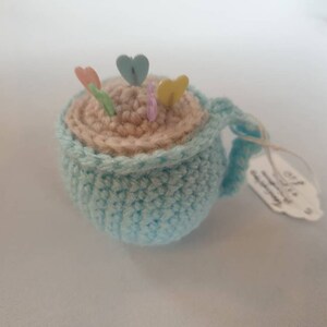 Tea cup pin cushion with pins image 2