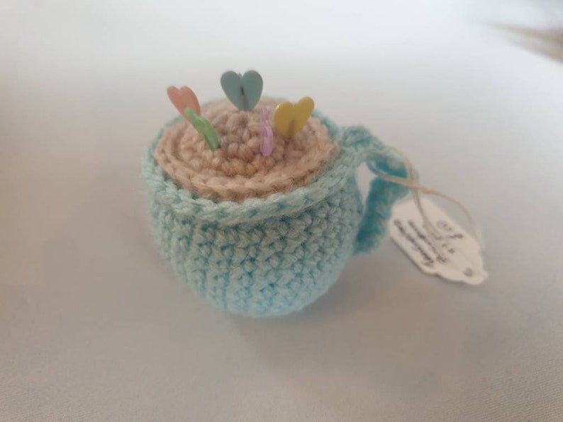 Tea cup pin cushion with pins image 2