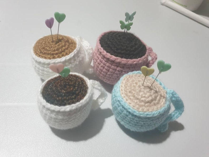 Tea cup pin cushion with pins image 1