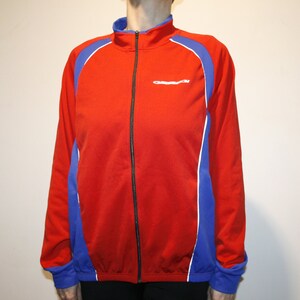 May include: Red, blue, and white zippered jacket with a white logo that says "Castelli" on the front.