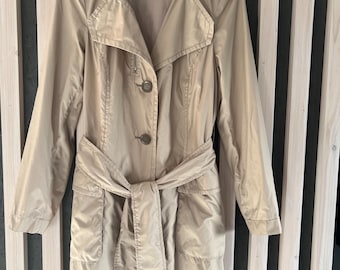 May include: A beige trench coat with a belt, two front pockets, and a button closure. The coat has a label that says "TUZZI".