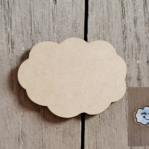 May include: Unfinished wooden cloud shape with a painted blue cloud with a smiling face and eyelashes on a wood background.