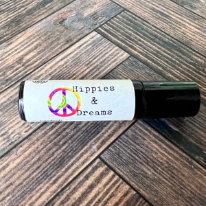 Hippies and Dreams fragrance roller ball fragrance by Teresa Lynns Simple Luxuries.  Presented in an amber roller bottle with a white oil resistant label and a tie dyed peace sign on the label.