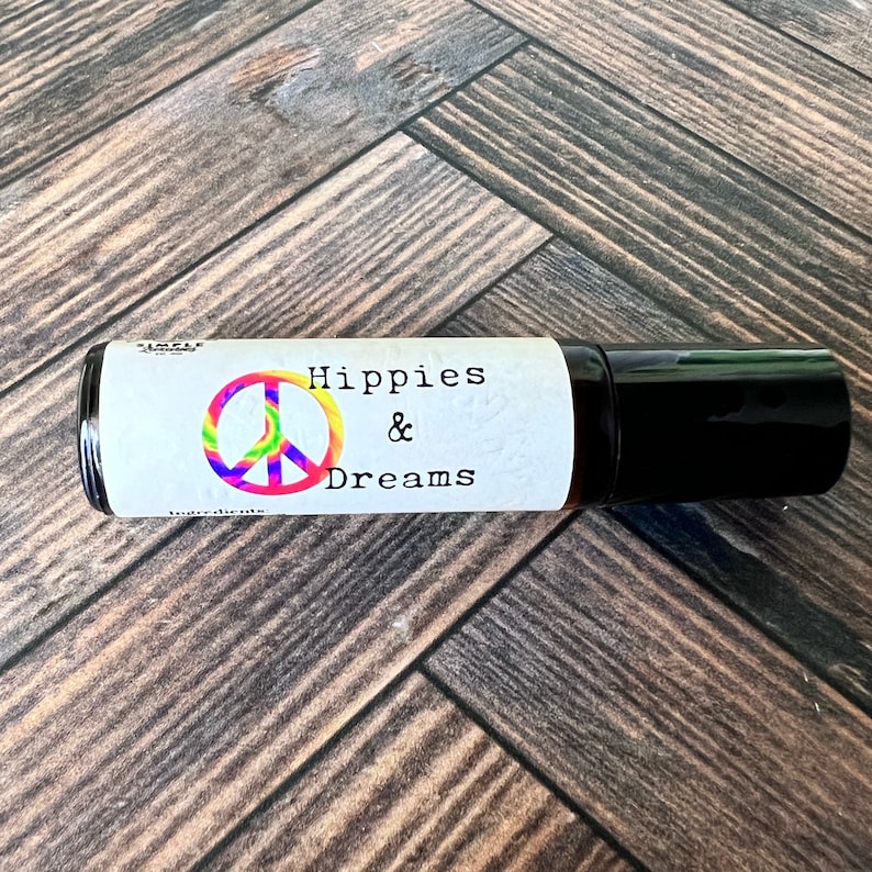 Hippies and Dreams fragrance roller ball fragrance by Teresa Lynns Simple Luxuries.  Presented in an amber roller bottle with a white oil resistant label and a tie dyed peace sign on the label.