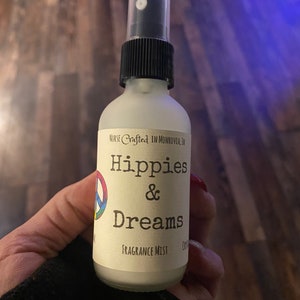 Hippies and Dreams fragrance mist by Teresa Lynns Simple Luxuries.  Presented in ar glass jars with a white linen label and a tie dyed peace sign on the label.