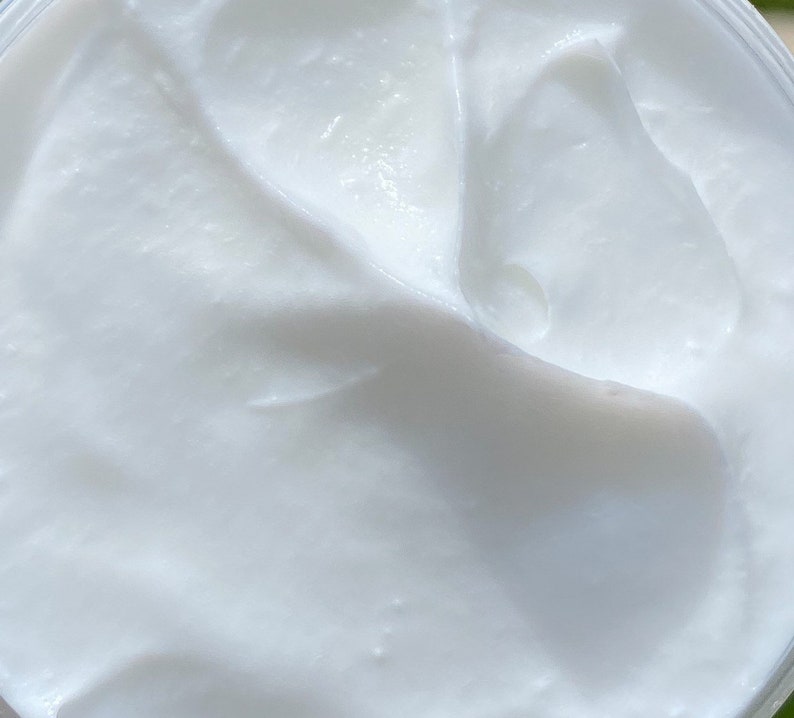 A close up of the thick white whipped body butter.