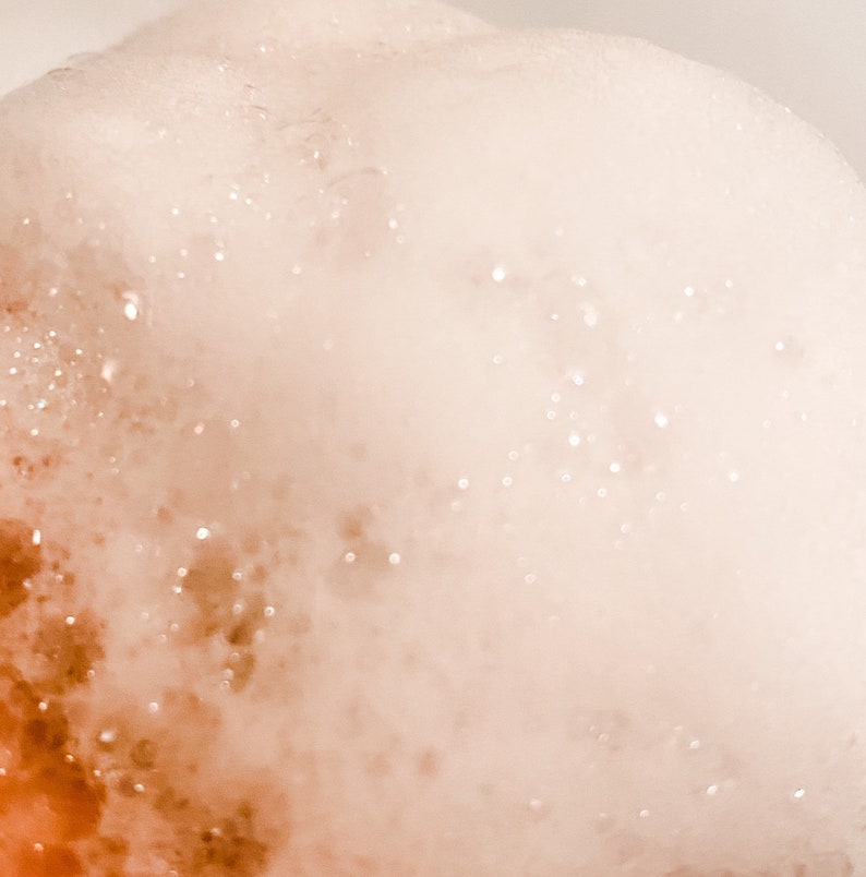 Thick bubbles are photographed up close to show the luxuries lather produced by this shower gel.